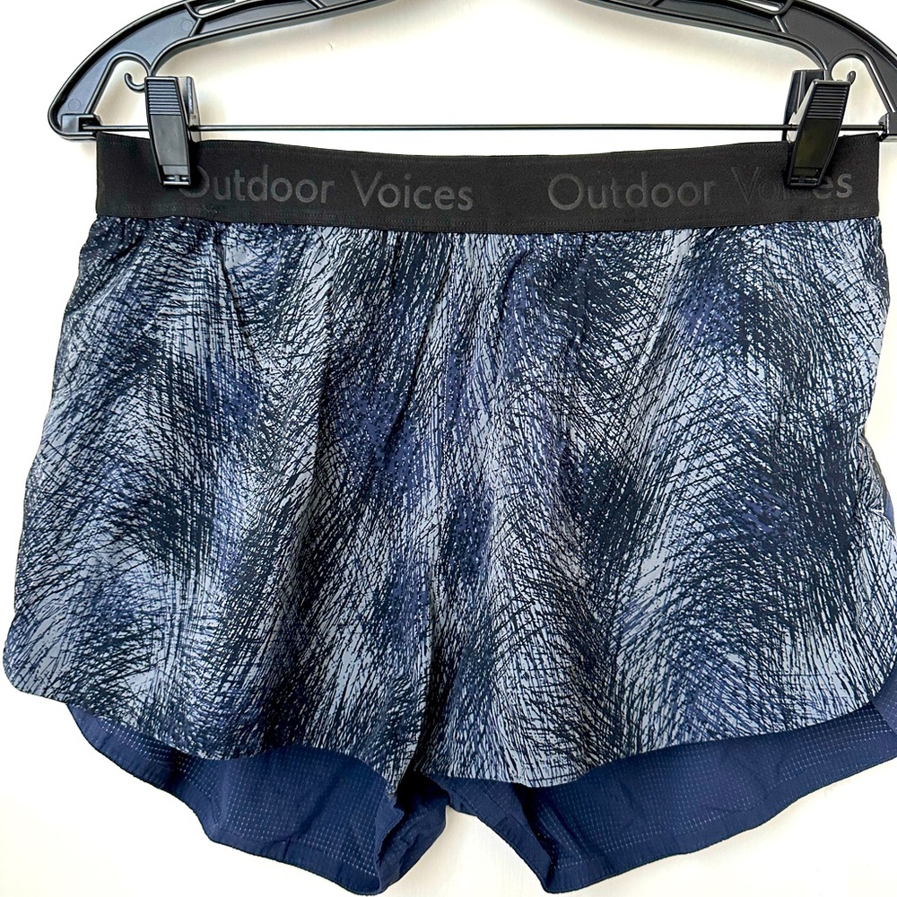 Outdoor Voices shorts, blue/black/gray patterned front, solid navy back, size L